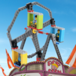 Blue sky with a Lego Ferris Wheel behind a carnival food stand.