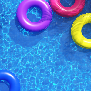 Blue swimming pool with blue, purple, pink and yellow float rings.