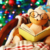 Teddy Bear reading a book in a comfortable chair in front of a Christmas tree.