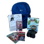 Nature Discovery Birding Backpack contents including books, brochures, and binoculars