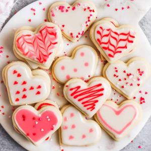 Heart sugar cookies decorates in whites and reds.